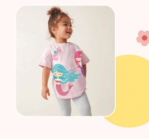 Detail of pink cotton girl's t-shirt featuring a cute mermaid and seahorse print pattern