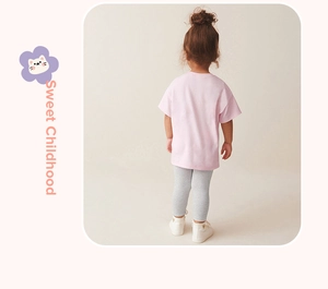 Rear view of a girl's pink short sleeve cotton t-shirt and grey leggings set