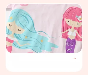 Detail of soft pink fabric featuring a cute cartoon mermaid water-based print