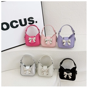 Children's mini bow handbag in six vibrant colors including pink, purple and silver
