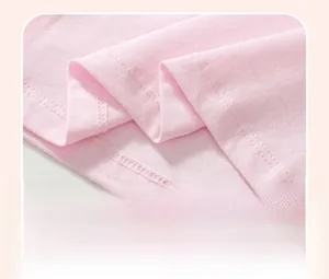 Close-up of pink cotton fabric hem with durable double-needle stitching and smooth finish