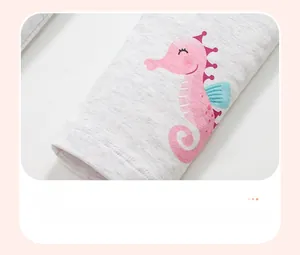 Detail showing high-quality pink seahorse print on grey cotton children knitwear