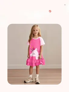 Close-up of pink cotton girl dress featuring a large unicorn print and ruffled hem detail