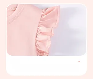 Detail of pink cotton girl t-shirt featuring smocked ruffle cuff sleeves and textured fabric