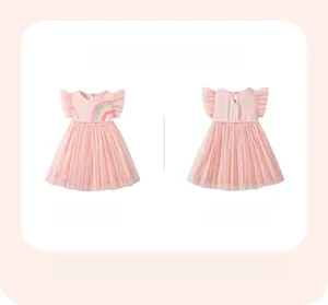 Detailed view of pink girls dress with rainbow embroidery and layered mesh skirt