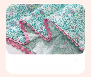 Detailed view of floral cotton fabric with precise pink wavy stitching and seam finishing