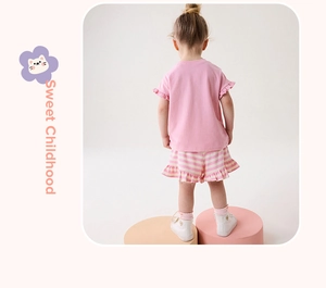 Rear view of girl summer set with pink t-shirt and striped shorts with ruffle details