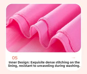 Détail de la couture surjetée durable sur la doublure intérieure rose de la robe fille