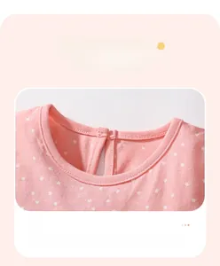 Detail of pink cotton dress neckline with white star prints and back button closure