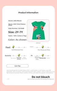 Detail view of green cotton girl dress with forest animal embroidery and fabric specs
