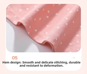 Detail of pink cotton fabric with white star patterns showing fine hemline stitching