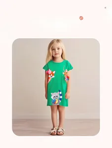 Detail showing cartoon animal embroidery and 3D mesh flower on green cotton dress