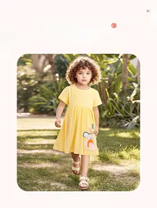 Detail of yellow cotton dress with white polka dots and cute cartoon mouse embroidery