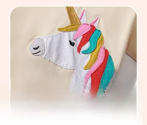 Close-up of colorful unicorn patchwork and embroidery on cotton kids short sleeve t-shirt
