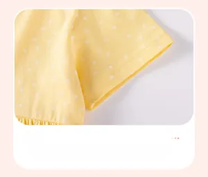 Detail of yellow cotton dress sleeve with white stars and neat stitching craftsmanship