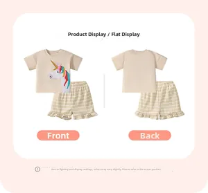 Flat lay of cotton kids summer set with unicorn t-shirt and ruffled striped shorts