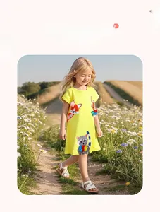 Outdoor shot of girls bright yellow short sleeve dress with cartoon fox and raccoon