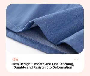 Dettaglio dell'orlo cucito durevole e della trama in denim twill dell'abito da bambina