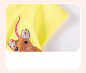 Detail of yellow cotton dress sleeve with cute mouse embroidery and floral ears