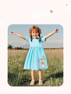 Detail of light blue polka dot cotton dress featuring a 3D mouse patch with pink tulle