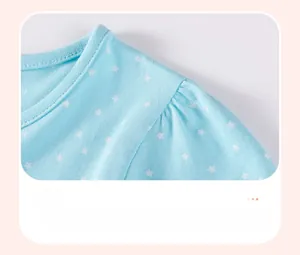 Close-up of gathered shoulder design on a light blue cotton dress with star pattern