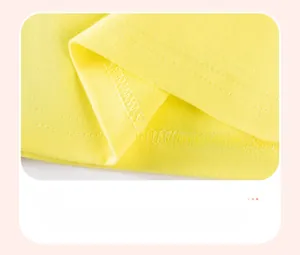 Detailed close-up of double-stitched hem and knit fabric on a yellow cotton dress