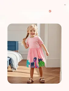 Girl's pink striped dress with colorful cartoon dinosaur prints in a home setting