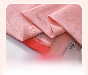 Close-up of pink cotton dress hem featuring precise double-needle stitching detail