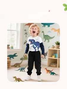 Detail of boys' dinosaur cotton T-shirt and black cargo pants set in a kid's room