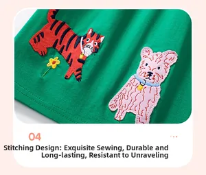 Detailed embroidery of tiger and dog motifs on green cotton summer dress hem