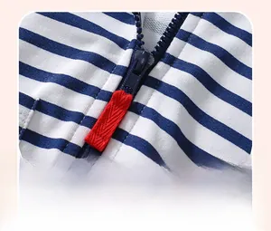 Detail of baby striped hoodie with durable navy zipper and red contrast puller