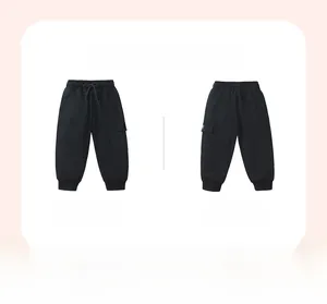 Detail view of black cargo sweatpants for kids with elastic waist and side pocket
