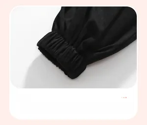 Detailed macro view of black cotton joggers showing durable elastic ribbed ankle cuffs