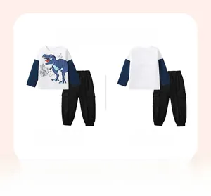 Detail of boys cotton two-piece set featuring a blue dinosaur print and cargo jogger pants