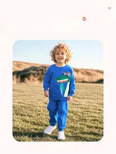 Close-up of kids blue tracksuit with cartoon crocodile graphic and elastic waistband