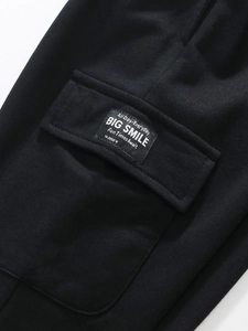 Girls black leggings detail with flap pocket and graphic square woven label