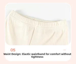 Detailed view of elastic waistband on off-white ribbed knit trousers for little girls