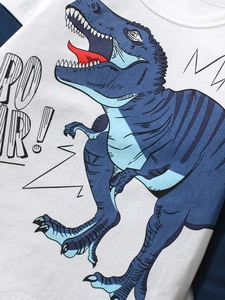 White cotton boys t-shirt with a blue cartoon dinosaur and Roar graphic print