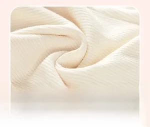 Detailed macro view of soft cream ribbed knit fabric texture for toddler clothing