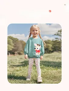 Close-up of girl outfit featuring light green deer sweatshirt and floral leggings