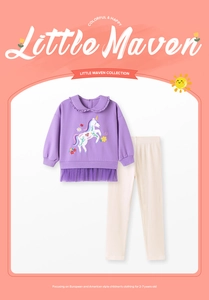 Detailed view of girl's purple sweatshirt featuring unicorn embroidery and tulle hem