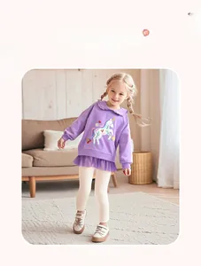 Detail of purple long-sleeve sweatshirt with unicorn embroidery and tulle hem design