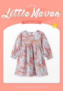 Detail of floral long sleeve girls dress featuring colorful smocking and pleated chest design