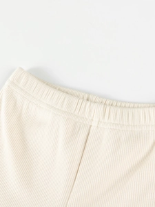 Cute beige ribbed knit pants for girls featuring an elastic waistband and soft fabric