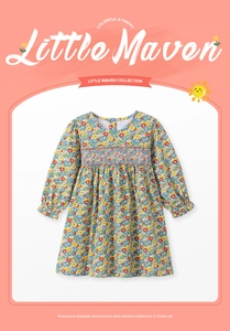 Detail of smocked chest design and floral pattern on girls' cotton long-sleeved dress