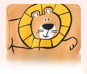 Close-up of mustard yellow cotton boy's shirt with cartoon lion offset print design