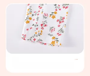 Detail view of floral knit fabric showing fine stitching and smooth hemline on pants cuff