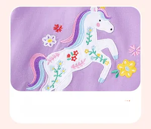 Detail view of cotton purple sweatshirt featuring unicorn and floral patchwork embroidery