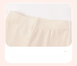 Close-up of elastic waistband on off-white ribbed leggings for toddler girls