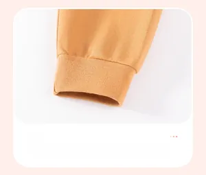 Detailed view of ginger cotton joggers with ribbed cuffs and reinforced stitching